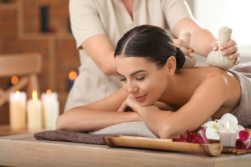 Beautiful young woman relaxing in spa salon